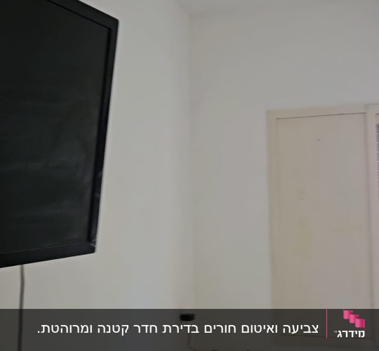 חדר מגורים מרוהט עם קירות ותקרה צבועים בלבן אחיד